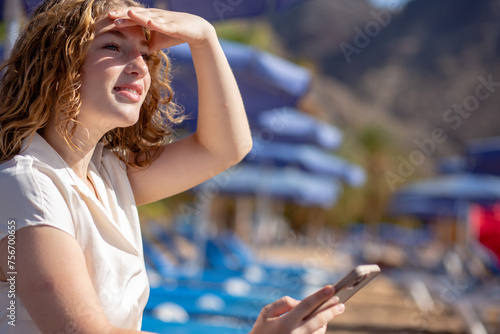 Young woman looking for address on her mobile phone