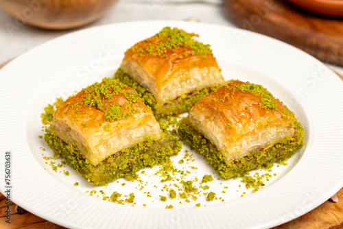 Baklava with pistachios on a wooden background. Turkish cuisine delicacies. Ramadan Dessert. local name kuru baklava