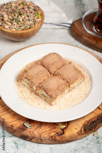 Cold baklava with pistachios on a wooden background. Turkish cuisine delicacies. Ramadan Dessert. local name soğuk baklava