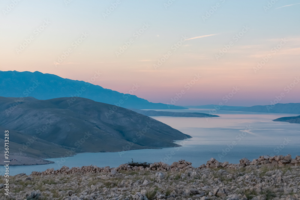 Fototapeta premium Panoramic sunrise view of deserted island Prvic seen from idyllic hiking trail near coastal town Baska, Krk Otok, Primorje-Gorski Kotar, Croatia, Europe. Majestic coastline Mediterranean Adriatic Sea