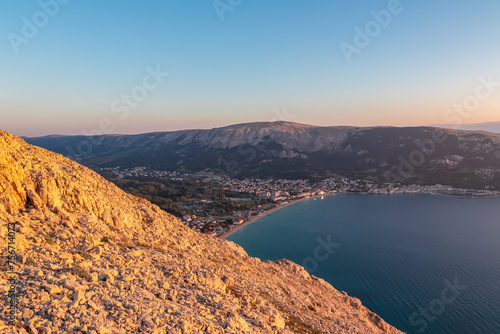 Scenic sunrise view of majestic coastline of Mediterranean Adriatic Sea near coastal town Baska, Krk Island, Primorje-Gorski Kotar, Croatia, Europe. Aerial vistas from idyllic hiking trail in summer photo