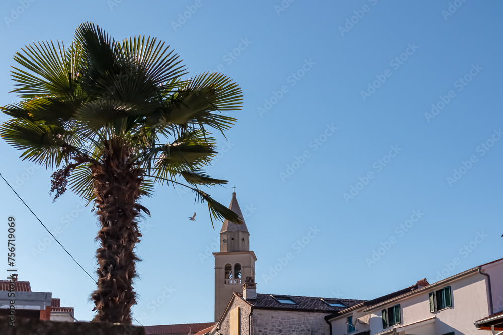 Obraz premium Scenic view of parish church of Saint Bernard in city centre of coastal town Funtana, Istria, Croatia. Adriatic Mediterranean architecture. Travel destination concept in summer. Tourism. Blue sky