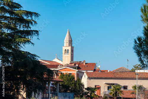 Scenic view of parish church of Saint Bernard in city centre of coastal town Funtana, Istria, Croatia. Adriatic Mediterranean architecture. Travel destination concept in summer. Tourism. Blue sky