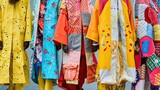 Colorful traditional japanese kimono in the street market. A collage-style image showcasing a variety of patched-up garments, symbolizing renewal and readiness. Vibrant colors and eclectic patterns.