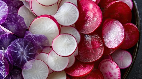 Radish slices background, radish slices background, radish slices. A colorful mix of sliced radishes, featuring red, white, and purple varieties, arranged in a harmonious pattern.