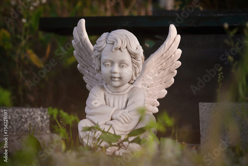 Little white angel sitting (concept of loss)