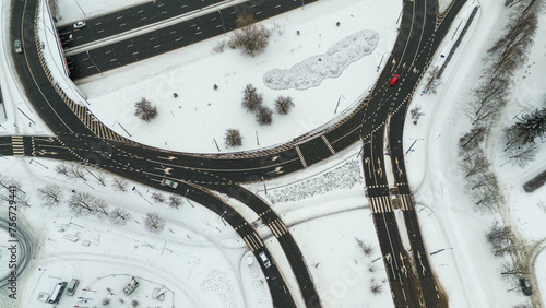 Drone photography of multiple lane street in a city going to a roundabout during winter day photo