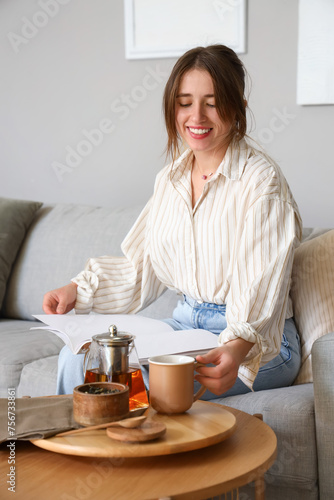 Young woman with hot tea re...