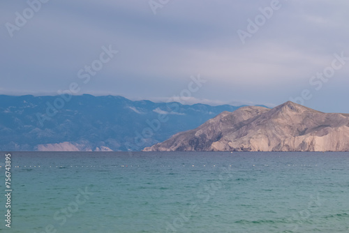Scenic view of deserted island Prvic seen from beach in coastal town Baska, Krk Otok, Primorje-Gorski Kotar, Croatia, Europe. Majestic coastline of Mediterranean Adriatic Sea in Kvarner bay in summer