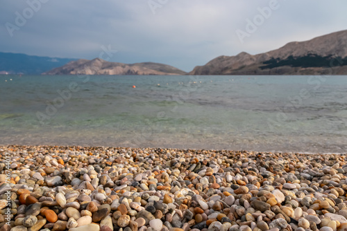 Paradise pebble beach in idyllic coastal town Baska, Krk Island, Primorje-Gorski Kotar, Croatia, Europe. Panoramic view of majestic coastline of Mediterranean Adriatic Sea in summer. Colourful stones