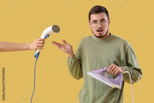 Shocked young man with iron...