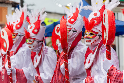 People in costumes are seen during carnival in the city of Maragogipe in Bahia. photo