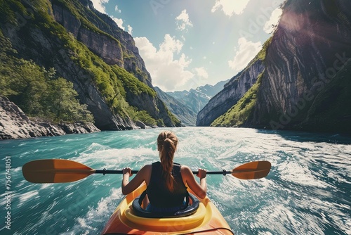 A girl in a kayak sailing on a mountain river. whitewater kayaking, down a white water rapid river in the mountains. photo