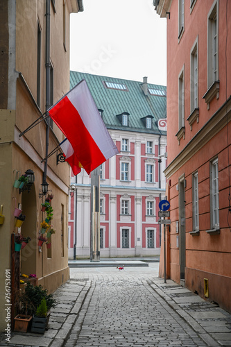 Polish Flag in Polish Street in front of Basilica of Our Lady of Perpetual Help, Mary Magdalene and St. Stanislaus, Poznan Poland photo
