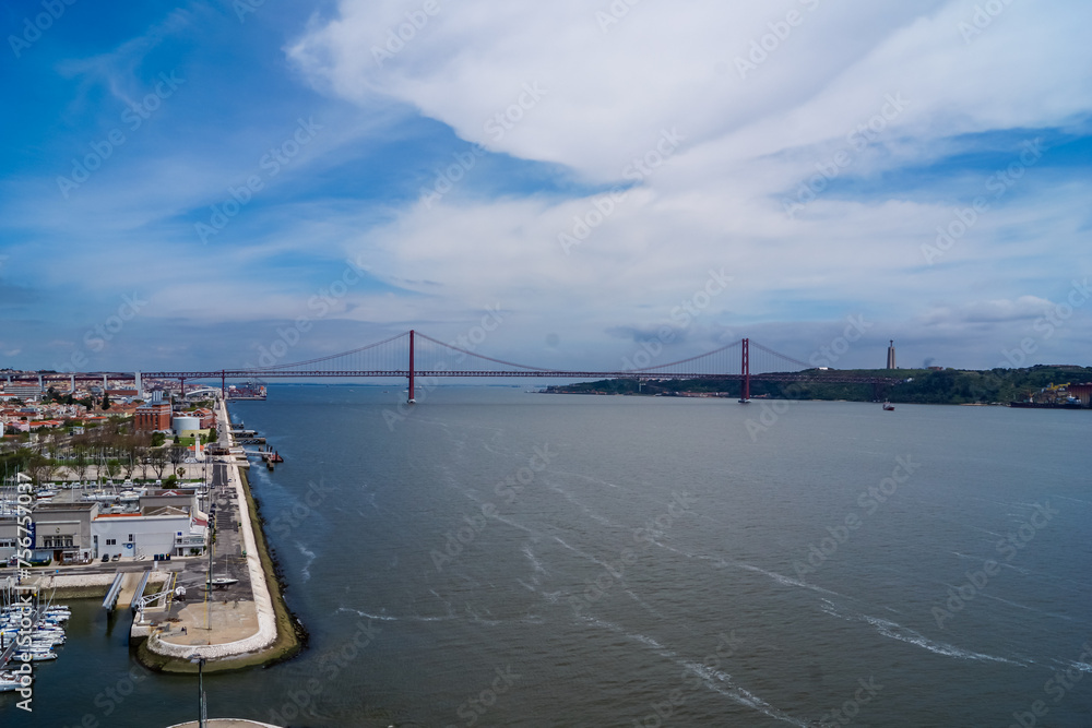 Panoramic view of the 25 de Abril Bridge in Lisboa, Portugal. Suspension bridge connecting the city of Lisbon to the municipality of Almada, over Tejo river. tranquil serene atmosphere. Road trip Panoramic view of the 25 de Abril Bridge in Lisboa, Portugal. Suspension bridge connecting the city of Lisbon to the municipality of Almada, over Tejo river. tranquil serene atmosphere. Road trip