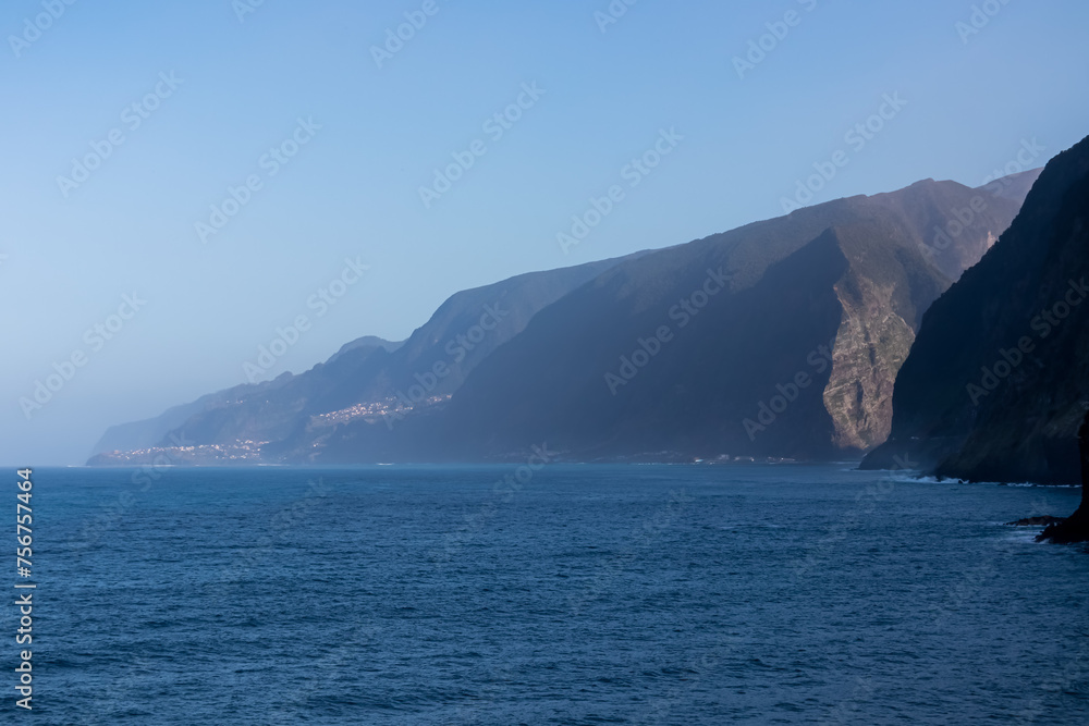 Panoramic view of majestic Atlantic Ocean seen from idyllic volcanic black sand beach Praia Seixal, Porto Moniz, Madeira island, Portugal, Europe. Surrounded by steep cliffs creating dramatic backdrop