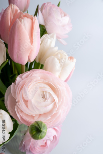 Blooming delicate spring flowers. Festive background, pastel and soft bouquet of floral card. Delicate ranunculus. Top view with copy space 