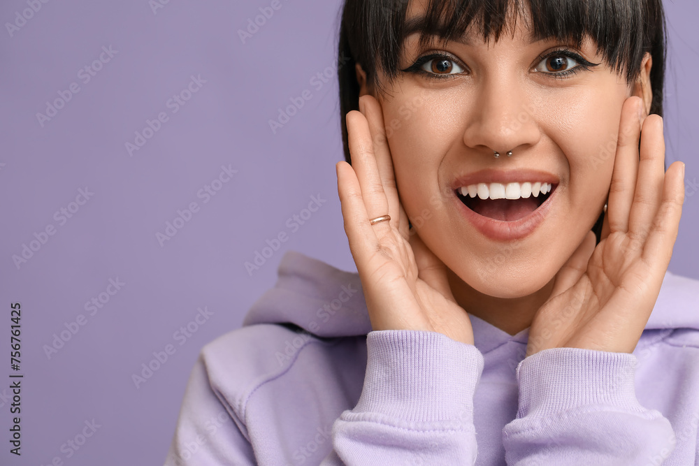 Happy stylish young woman with nose piercing on lilac background Happy stylish young woman with nose piercing on lilac background