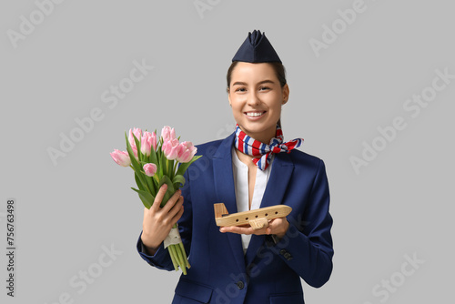 Young stewardess with pink ...