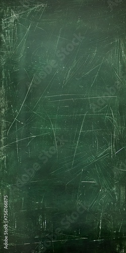 A school green chalkboard texture features a grainy, rough pattern characteristic of its slate surface. School green board with signs of use from many classes and lessons.