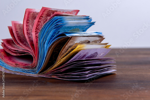 Hungarian HUF banknotes, pile of money on a brown wooden table photo