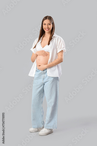 Smiling pregnant woman hold...
