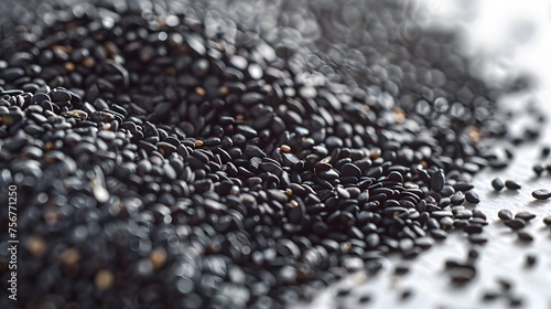 Close-up of black sesame seeds over white background