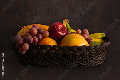 Half-lit still life of seasonal fruits photo