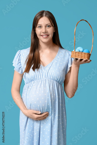 Smiling pregnant woman hold...