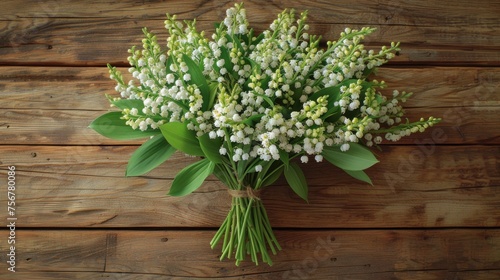 a bouquet of white flowers sitting on top of a wooden table next to a green leafy plant on top of a wooden table.