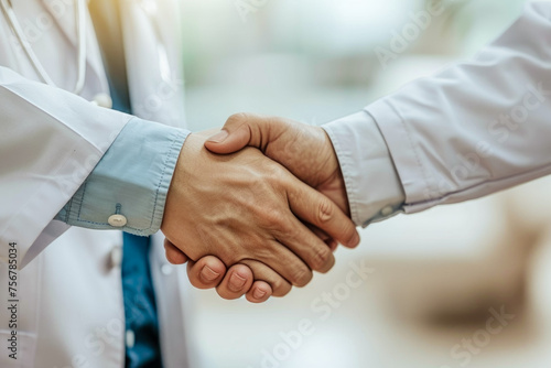 The mutual gesture of a doctor and a patient shaking hands, symbolizing trust and camaraderie.