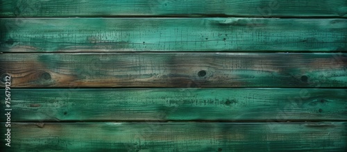 A close up of a green wooden wall with a unique pattern of rectangular shapes. The wood has a hint of aqua and electric blue, creating an artistic look