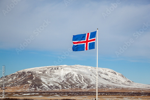 Iceland flag flying with mountain in background
