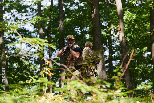 A specialized military antiterrorist unit conducts a covert operation in dense, hazardous woodland, demonstrating precision, discipline, and strategic readiness © .shock