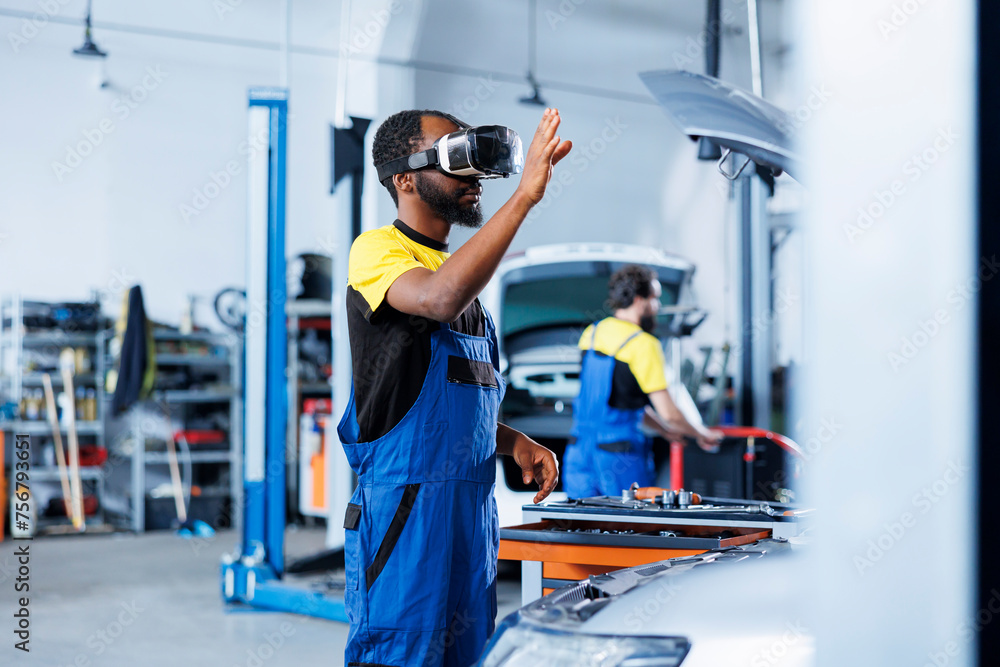 African american engineer in auto repair shop using virtual reality to visualize car battery in order to fix it. Skilled garage worker wearing futuristic vr headset while working on broken vehicle African american engineer in auto repair shop using virtual reality to visualize car battery in order to fix it. Skilled garage worker wearing futuristic vr headset while working on broken vehicle