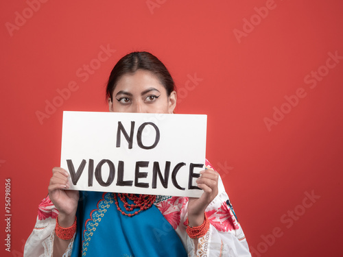 latina girl in kichwa costume holding a sign with a 