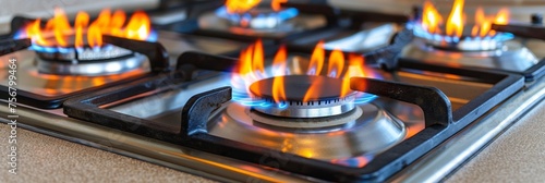 Close up of blue fire from domestic kitchen stove top with propane gas flames and copy space © Ilja