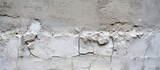 A detailed shot of a weathered concrete wall showing cracks caused by freezing water, atmospheric phenomena, and other natural events