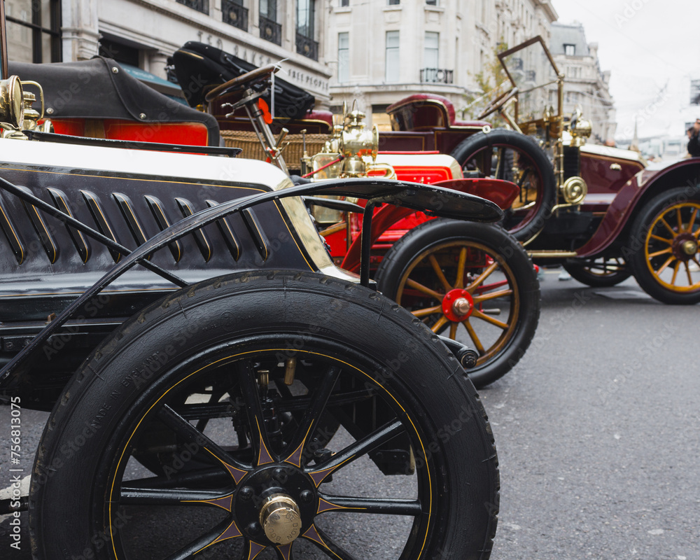 Side view of the front of a row of vintage cars ready for the London to Brighton Rally