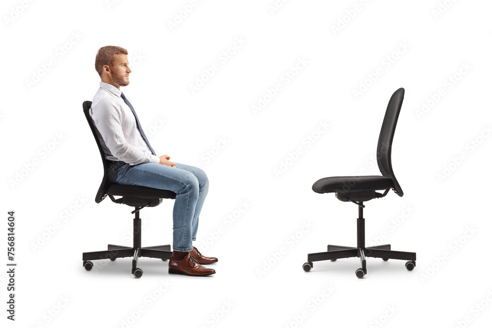 Profile shot of a businessman sitting in an office chair opposite an empty chair Profile shot of a businessman sitting in an office chair opposite an empty chair