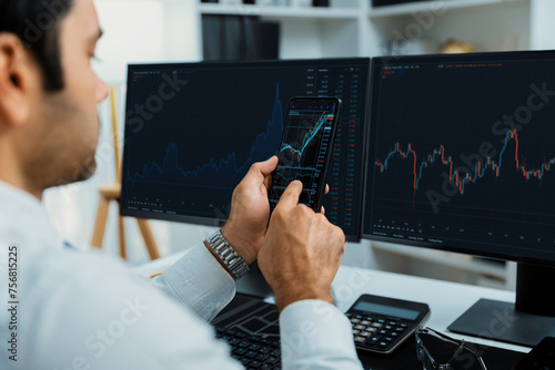 Trader businessman searching on smartphone, analyzing in dynamic stock exchange investment screen on pc with invest highest profitable financial technology market at modern home office. Surmise.