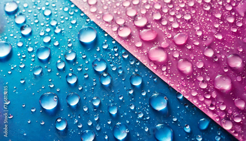 The background features a blend of blue, pink, and purple colors, with water droplets scattered throughout. The droplets create a shiny and reflective surface, adding texture