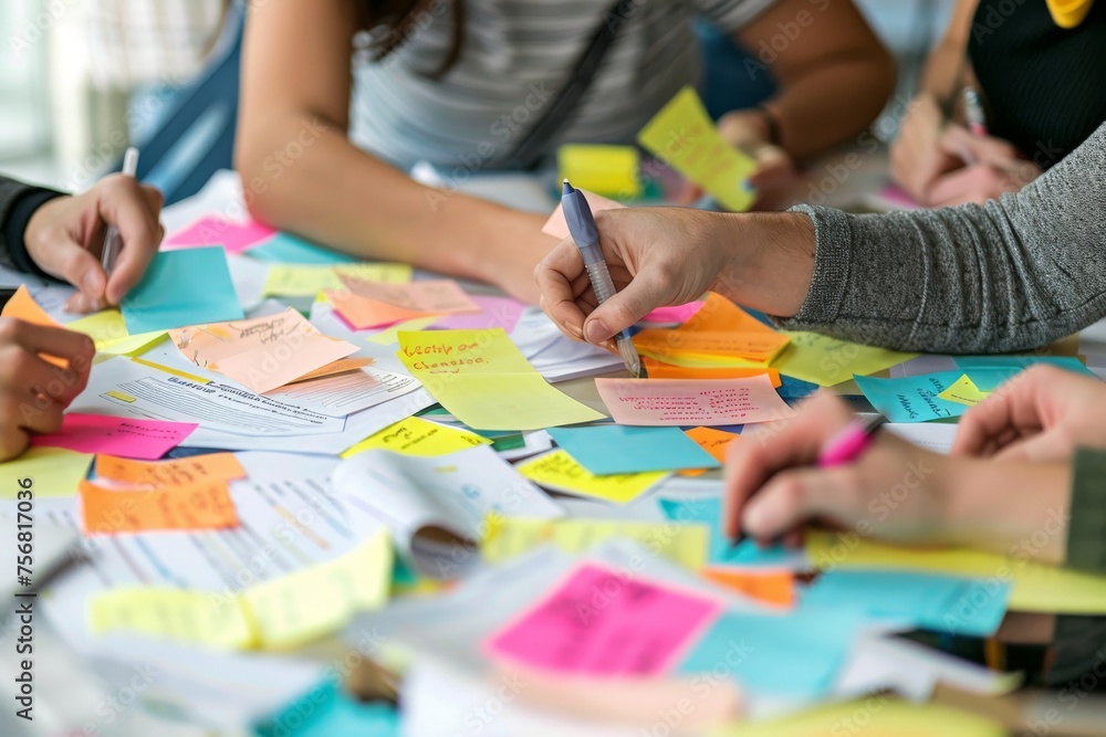 A collaborative team engages in a brainstorming session with colorful sticky notes on a table for idea generation