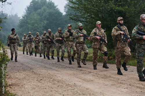 An elite military unit, led by a major, confidently parades through dense forest, showcasing precision, discipline, and readiness for high-risk operations