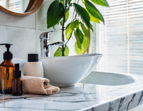 Toiletries and empty space on a white marble tabletop in a modern bright and clean bathroom.