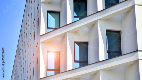 View of a white modern apartment building. Perfect symmetry with blue sky. Geometric architecture detail modern concrete structure building. Abstract concrete architecture. 