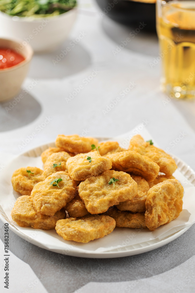 Fast food chicken nuggets paired with a glass of apple juice Fast food chicken nuggets paired with a glass of apple juice