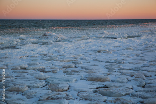 Frozen beach and water at sunset on Baltic sea, Saarema island, Estonia