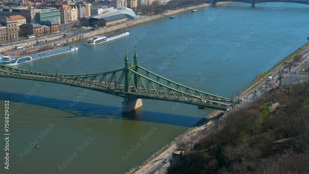 Ships on danube against capital. A view of Liberty bridge over Danube river in the Budapest city during day time. Ships on danube against capital. A view of Liberty bridge over Danube river in the Budapest city during day time.