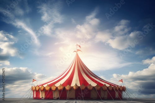 Red and white circus tent against blue sky